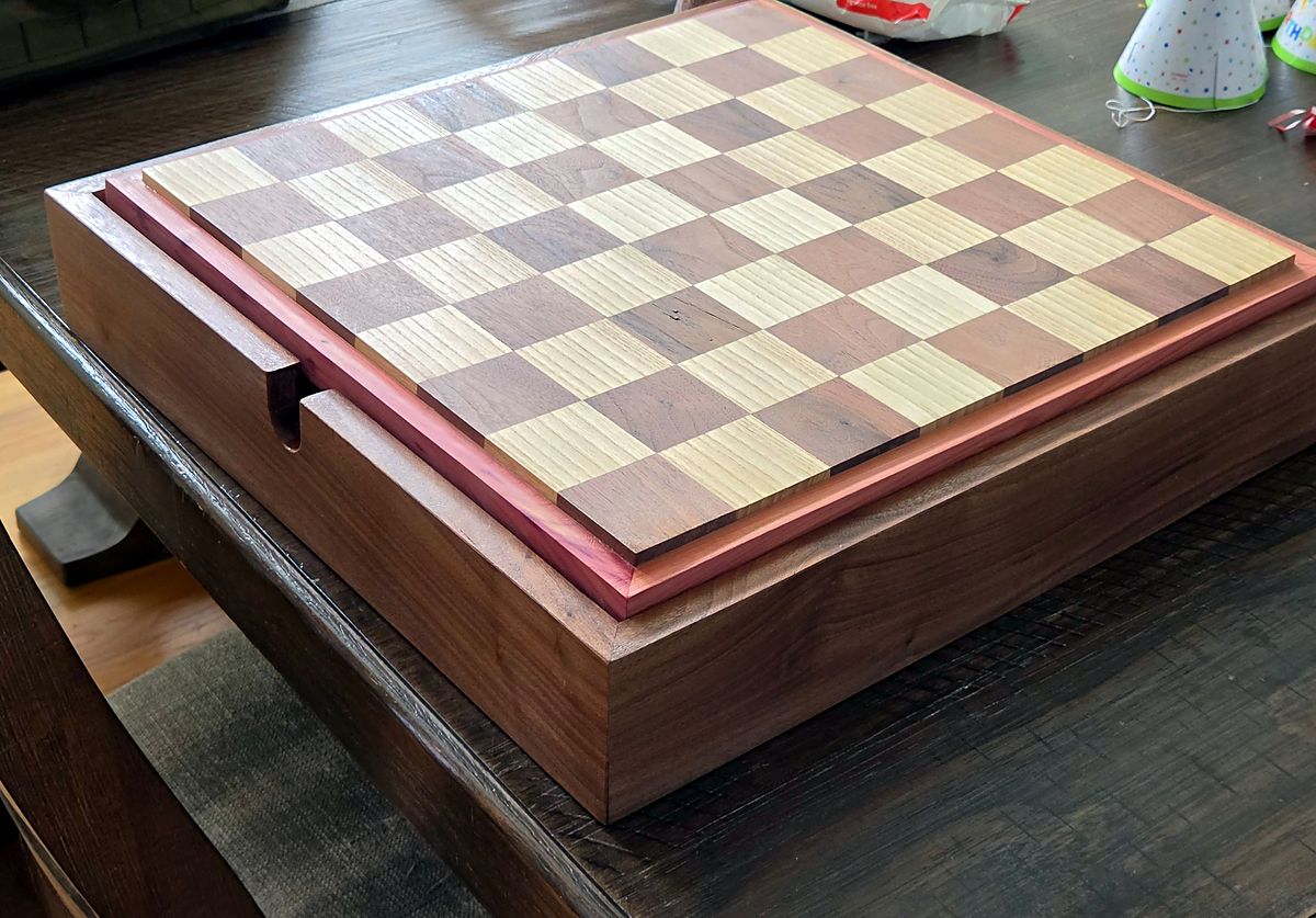 Chess board in walnut and ash with a cedar border on a walnut box