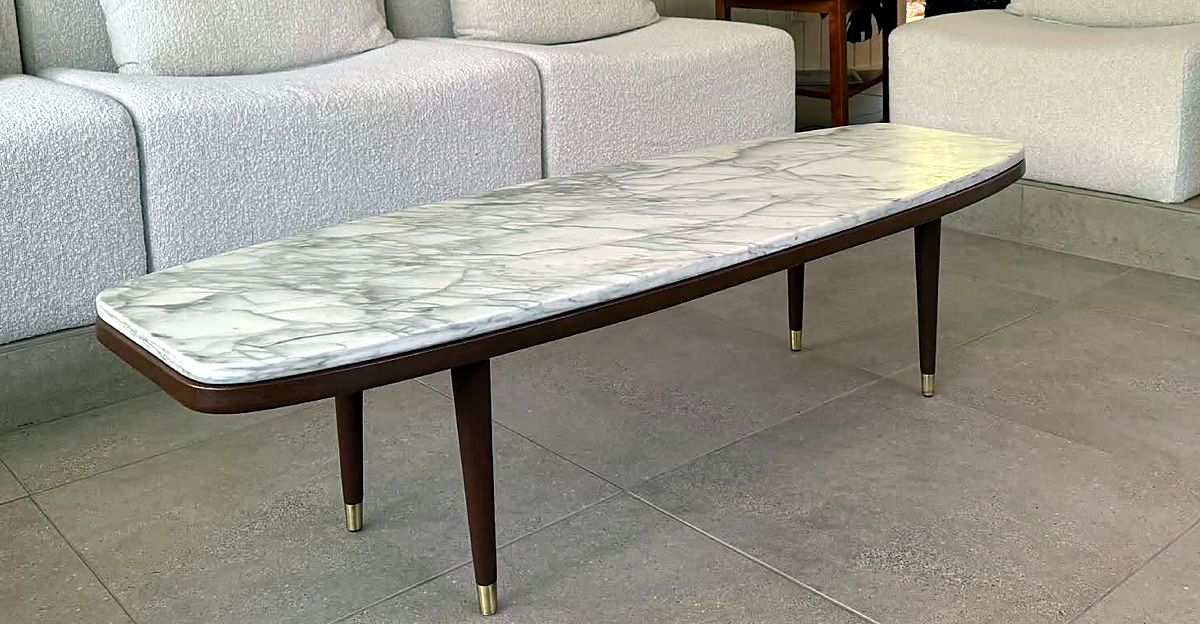 Mid-century coffee table with a marble top and brass-tipped legs