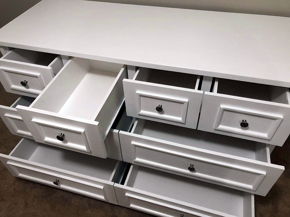 White six-drawer dresser with raised-panel drawer fronts