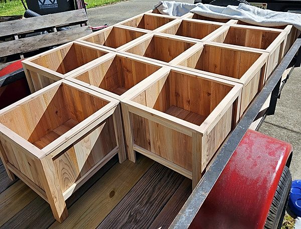 A group of cedar planter boxes on a trailer
